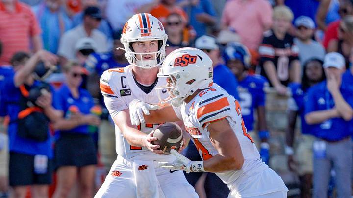 Oklahoma State quarterback Drew Mestemaker hands off the ball to Oklahoma State running back Caleb Hawkins. Oklahoma State quarterback Drew Mestemaker hands off the ball to Oklahoma State running back Caleb Hawkins.