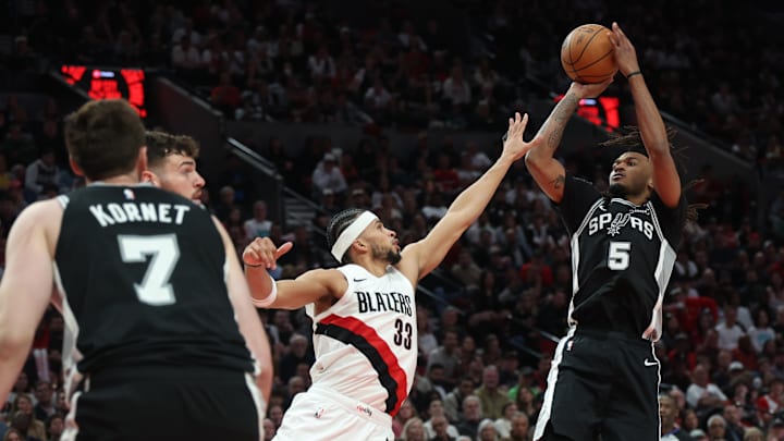 Apr 24, 2026; Portland, Oregon, USA; San Antonio Spurs guard Stephon Castle (5) shoots the ball over Portland Trail Blazers forward Toumani Camara (33) during the second half during Game 3 of the first round of the 2026 NBA Playoffs at Moda Center.