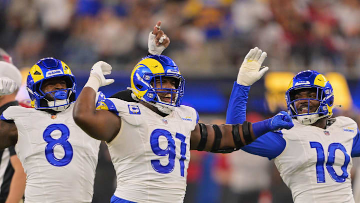 Nov 23, 2025; Inglewood, California, USA; Los Angeles Rams defensive end Kobie Turner (91) celebrates with linebackers Jared Verse (8) and Josaiah Stewart (10) after sacking Tampa Bay Buccaneers quarterback Baker Mayfield (not pictured) during the second quarter at SoFi Stadium. Mandatory Credit: Jayne Kamin-Oncea-Imagn Images Nov 23, 2025; Inglewood, California, USA; Los Angeles Rams defensive end Kobie Turner (91) celebrates with linebackers Jared Verse (8) and Josaiah Stewart (10) after sacking Tampa Bay Buccaneers quarterback Baker Mayfield (not pictured) during the second quarter at SoFi Stadium. Mandatory Credit: Jayne Kamin-Oncea-Imagn Images