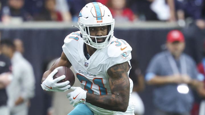 Dec 15, 2024; Houston, Texas, USA; Miami Dolphins running back Raheem Mostert (31) runs with the ball during the game against the Houston Texans at NRG Stadium. Mandatory Credit: Troy Taormina-Imagn Images