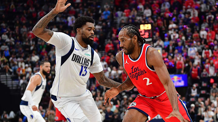 Apr 4, 2025; Inglewood, California, USA; Los Angeles Clippers forward Kawhi Leonard (2) moves the ball against Dallas Mavericks forward Naji Marshall (13) during the first half at Intuit Dome. Mandatory Credit: Gary A. Vasquez-Imagn Images
