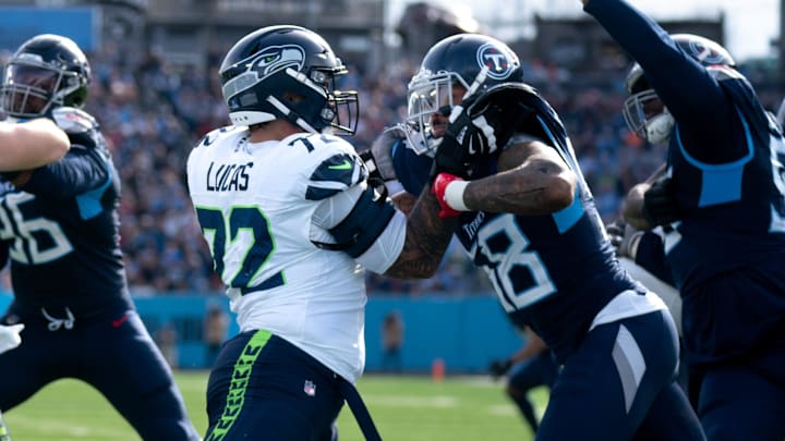 Seattle Seahawks offensive tackle Abraham Lucas (72) and Tennessee Titans linebacker Harold Landry III (58) battle during their game at Nissan Stadium in Nashville, Tenn., Sunday, Dec. 24, 2023.