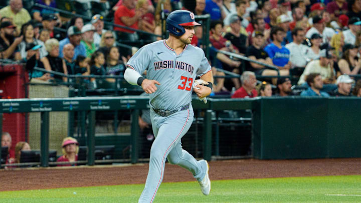 May 31, 2025; Phoenix, Arizona, USA;  Washington Nationals infielder Nathaniel Lowe (33) comes in to score the third run of the first inning against the Arizona Diamondbacks at Chase Field. 