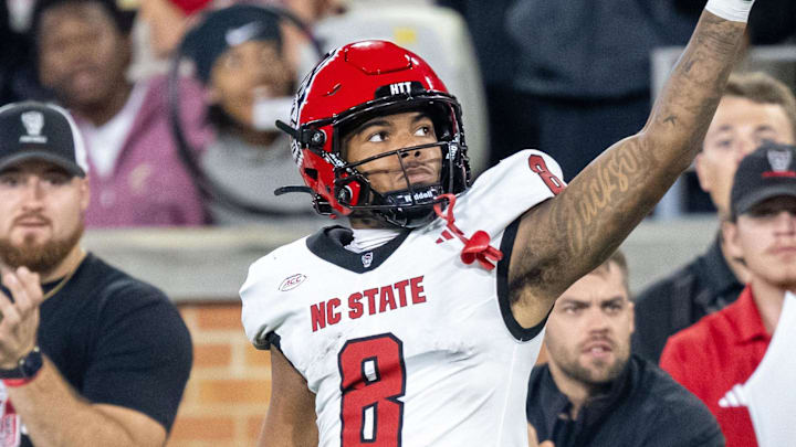 Sep 11, 2025; Winston-Salem, North Carolina, North Carolina State Wolfpack wide receiver Keenan Jackson (8) celebrates a first down against the Wake Forest Demon Deacons defensive back Karon Prunty (3) in second half at Allegacy Federal Credit Union Stadium. Mandatory Credit: Luke Jamroz-Imagn Images 