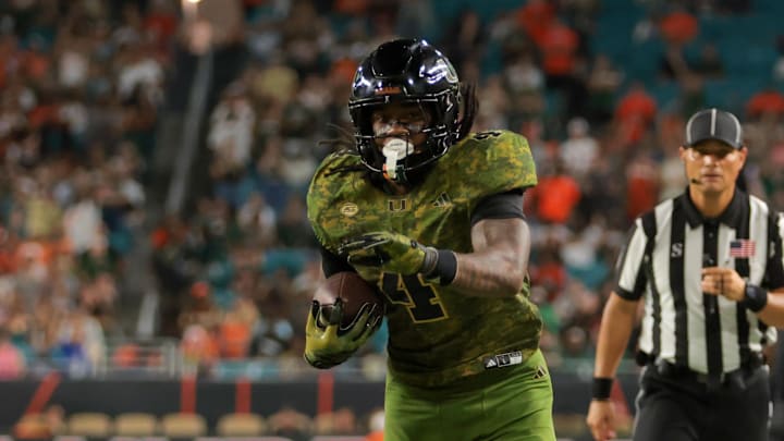 Oct 25, 2025; Miami Gardens, Florida, USA; Miami Hurricanes running back Mark Fletcher Jr. (4) carries the football against Stanford Cardinal safety Mitch Leigber (32) during the third quarter at Hard Rock Stadium. Mandatory Credit: Sam Navarro-Imagn Images Oct 25, 2025; Miami Gardens, Florida, USA; Miami Hurricanes running back Mark Fletcher Jr. (4) carries the football against Stanford Cardinal safety Mitch Leigber (32) during the third quarter at Hard Rock Stadium. Mandatory Credit: Sam Navarro-Imagn Images