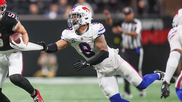Buffalo Bills linebacker Terrel Bernard (8) attempts to drag down Atlanta Falcons wide receiver Drake London (5) during the first half of a game at Mercedes-Benz Stadium.