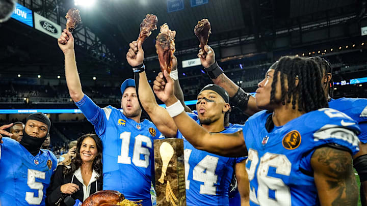 Detroit Lions quarterback Jared Goff (16), defensive tackle DJ Reader (98), wide receiver Amon-Ra St. Brown (14), running back Jahmyr Gibbs (26), linebacker Al-Quadin Muhammad (69) celebrate their win against the Chicago Bears with a turkey drumstick after winning 23-20 on Thanksgiving Day at Ford Field in Detroit on Thursday, Nov. 28, 2024. Detroit Lions quarterback Jared Goff (16), defensive tackle DJ Reader (98), wide receiver Amon-Ra St. Brown (14), running back Jahmyr Gibbs (26), linebacker Al-Quadin Muhammad (69) celebrate their win against the Chicago Bears with a turkey drumstick after winning 23-20 on Thanksgiving Day at Ford Field in Detroit on Thursday, Nov. 28, 2024.