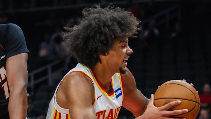 Oct 13, 2025; Atlanta, Georgia, USA; Atlanta Hawks forward Asa Newell (14) protects the ball against Miami Heat guard Dru Smith (12) during the first quarter at State Farm Arena. Mandatory Credit: Jordan Godfree-Imagn Images