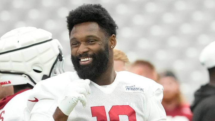 Arizona Cardinals linebacker Josh Sweat (10) talks with teammates during training camp July 27, 2025.