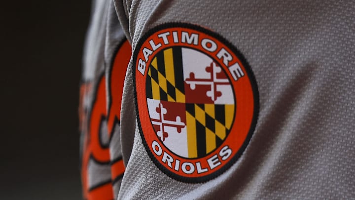 May 5, 2024; Cincinnati, Ohio, USA; The Baltimore Orioles logo on the sleeve of designated hitter Gunnar Henderson (2) as he prepares on deck during the seventh inning against the Cincinnati Reds at Great American Ball Park. Mandatory Credit: Katie Stratman-Imagn Images May 5, 2024; Cincinnati, Ohio, USA; The Baltimore Orioles logo on the sleeve of designated hitter Gunnar Henderson (2) as he prepares on deck during the seventh inning against the Cincinnati Reds at Great American Ball Park. Mandatory Credit: Katie Stratman-Imagn Images