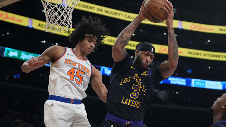 Dec 18, 2023; Los Angeles, California, USA; Los Angeles Lakers forward Anthony Davis (3) rebounds the ball against New York Knicks center Jericho Sims (45) in the second half at Crypto.com Arena. Mandatory Credit: Kirby Lee-Imagn Images