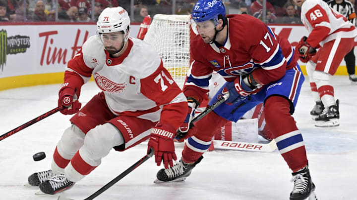 Apr 8, 2025; Montreal, Quebec, CAN; Detroit Red Wings forward Dylan Larkin (71) plays the puck and Montreal Canadiens forward Josh Anderson (17) forechecks during the second period at the Bell Centre. Mandatory Credit: Eric Bolte-Imagn Images