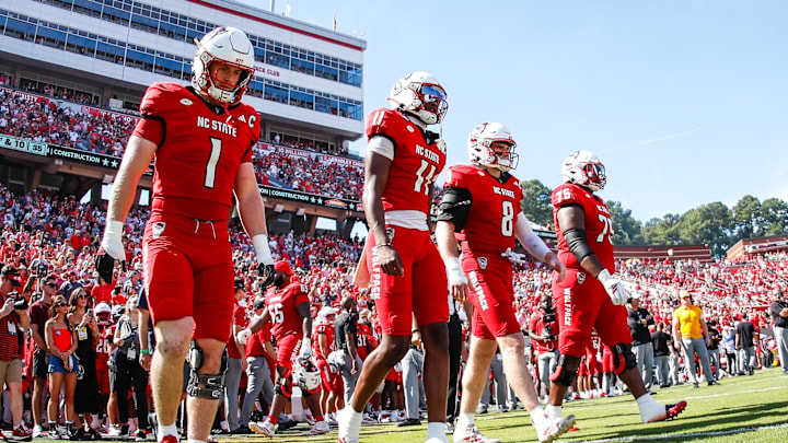 Oct 4, 2025; Raleigh, North Carolina, USA; NC State Wolfpack quarterback CJ Bailey (11), linebacker Caden Fordham (1), wide receiver Keenan Jackson (8) and offensive lineman Jr. Anthony Carter (75) walk out for the coin toss prior to the first half of the game against Campbell Fighting Camels at Carter-Finley Stadium. Mandatory Credit: Jaylynn Nash-Imagn Images Oct 4, 2025; Raleigh, North Carolina, USA; NC State Wolfpack quarterback CJ Bailey (11), linebacker Caden Fordham (1), wide receiver Keenan Jackson (8) and offensive lineman Jr. Anthony Carter (75) walk out for the coin toss prior to the first half of the game against Campbell Fighting Camels at Carter-Finley Stadium. Mandatory Credit: Jaylynn Nash-Imagn Images