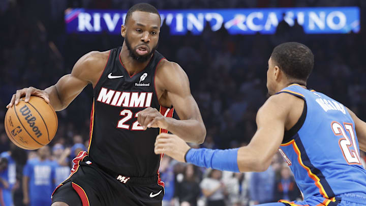 Feb 12, 2025; Oklahoma City, Oklahoma, USA; Miami Heat forward Andrew Wiggins (22) drives down the court against Oklahoma City Thunder guard Aaron Wiggins (21) during the first quarter at Paycom Center. Mandatory Credit: Alonzo Adams-Imagn Images