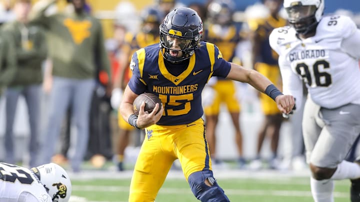 Nov 8, 2025; Morgantown, West Virginia, USA; West Virginia Mountaineers quarterback Scotty Fox Jr. (15) runs the ball during the second quarter against the Colorado Buffaloes at Milan Puskar Stadium. Mandatory Credit: Ben Queen-Imagn Images