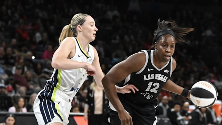 Jun 13, 2025; Las Vegas, Nevada, USA; Las Vegas Aces guard Chelsea Gray (12) drives past Dallas Wings guard Paige Bueckers (5) in the second quarter of their game at Michelob Ultra Arena. Mandatory Credit: Candice Ward-Imagn Images