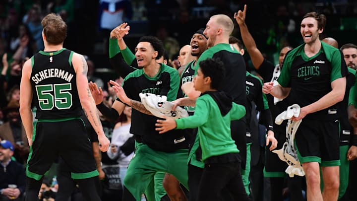 Boston Celtics forward Baylor Scheierman (55) reacts with the bench after hitting a three-point shot during the second half at TD Garden.