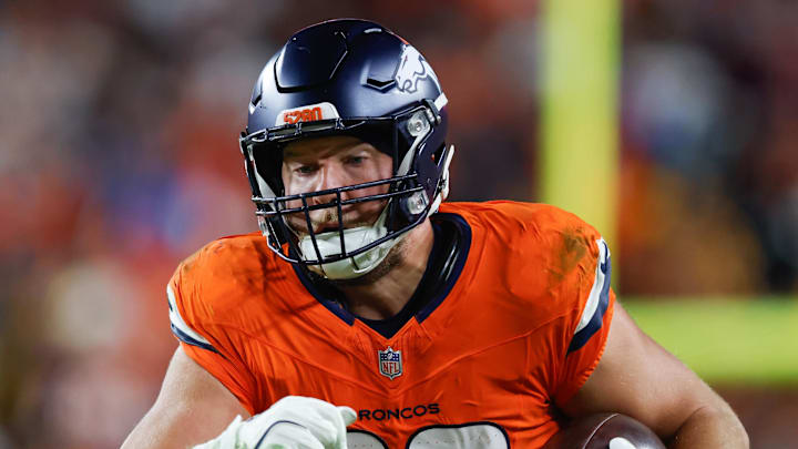 Nov 30, 2025; Landover, Maryland, USA; Denver Broncos tight end Adam Trautman (82) carries the ball after a reception against the Washington Commanders in the second quarter of the game at Northwest Stadium. Mandatory Credit: Peter Casey-Imagn Images