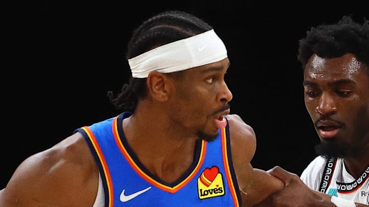 Feb 8, 2025; Memphis, Tennessee, USA; Oklahoma City Thunder guard Shai Gilgeous-Alexander (2) dribbles as Memphis Grizzlies guard Vince Williams Jr. (5) defends during the third quarter at FedExForum. Mandatory Credit: Petre Thomas-Imagn Images