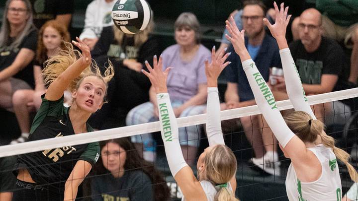 Iowa City West's Sophia Austen (16) hits the ball over the Cedar Rapids Kennedy defenders Aug. 25, 2026 during a volleyball match at Iowa City West High School in Iowa City, Iowa. Iowa City West's Sophia Austen (16) hits the ball over the Cedar Rapids Kennedy defenders Aug. 25, 2026 during a volleyball match at Iowa City West High School in Iowa City, Iowa.