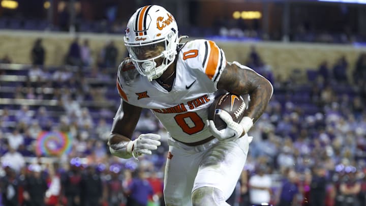 Nov 9, 2024; Fort Worth, Texas, USA; Oklahoma State Cowboys running back Ollie Gordon II (0) scores a touchdown past TCU Horned Frogs safety Jamel Johnson (2) during the second half at Amon G. Carter Stadium. Mandatory Credit: Kevin Jairaj-Imagn Images Nov 9, 2024; Fort Worth, Texas, USA; Oklahoma State Cowboys running back Ollie Gordon II (0) scores a touchdown past TCU Horned Frogs safety Jamel Johnson (2) during the second half at Amon G. Carter Stadium. Mandatory Credit: Kevin Jairaj-Imagn Images
