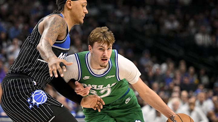 Apr 3, 2026; Dallas, Texas, USA; Dallas Mavericks forward Cooper Flagg (32) drives to the basket past Orlando Magic forward Paolo Banchero (5) during the first quarter at the American Airlines Center. Mandatory Credit: Jerome Miron-Imagn Images