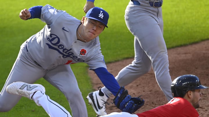 Dodgers starting pitcher Yoshinobu Yamamoto (18) tags out Cleveland Guardians second baseman Will Wilson (7) in the third inning at Progressive Field on Monday.