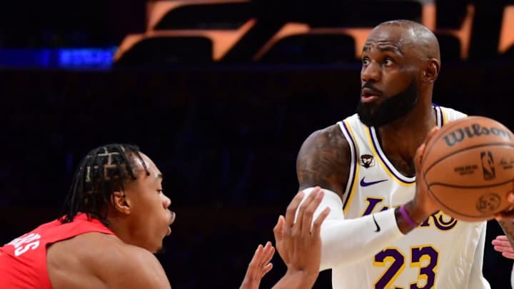 Los Angeles Lakers forward LeBron James controls the ball against Toronto Raptors forward Scottie Barnes.