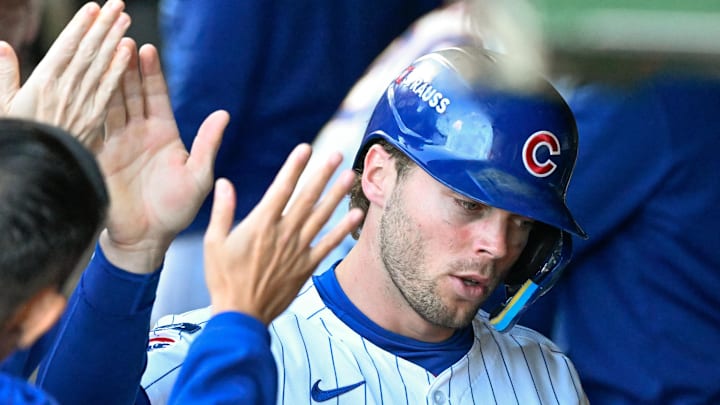 Oct 8, 2025; Chicago, Illinois, USA; Chicago Cubs second baseman Nico Hoerner (2) celebrates with teammates after scoring a run against the Milwaukee Brewers in the first inning during game three of the NLDS round for the 2025 MLB playoffs at Wrigley Field. Mandatory Credit: Matt Marton-Imagn Images