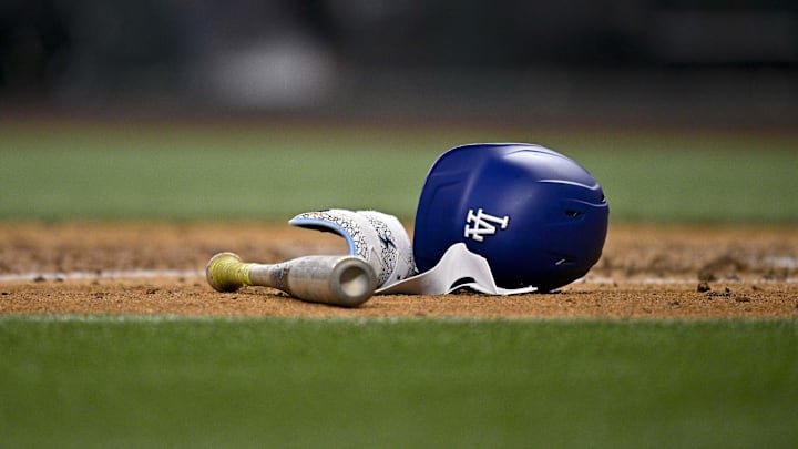 Apr 20, 2025; Arlington, Texas, USA; A view of a Los Angeles Dodgers batting helmet and bat during the game between the Texas Rangers and the Los Angeles Dodgers at Globe Life Field. Mandatory Credit: Jerome Miron-Imagn Images