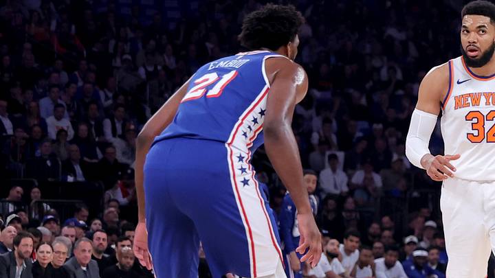 Knicks center Karl-Anthony Towns controls the ball against Joel Embiid.