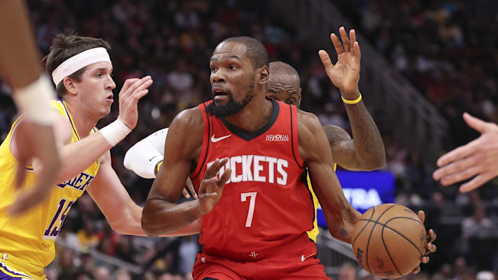 Mar 16, 2026; Houston, Texas, USA; Houston Rockets forward Kevin Durant (7) dribbles the ball as Los Angeles Lakers guard Austin Reaves (15) defends during the first quarter at Toyota Center. Mandatory Credit: Troy Taormina-Imagn Images