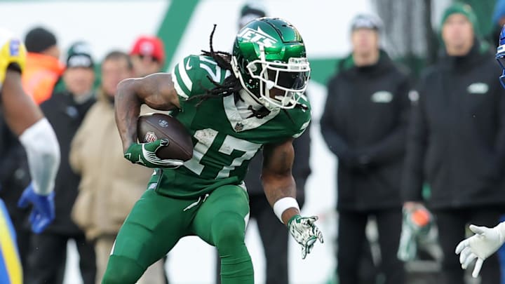 Dec 22, 2024; East Rutherford, New Jersey, USA; New York Jets wide receiver Davante Adams (17) runs with the ball against Los Angeles Rams safety Kamren Kinchens (26) and cornerback Ahkello Witherspoon (4) during the fourth quarter at MetLife Stadium. Mandatory Credit: Brad Penner-Imagn Images