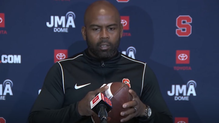 October 13, 2025; Syracuse, New York, USA; Syracuse coach Fran Brown, holding his beloved football, addresses the media at his weekly news conference at the John A. Lally Athletics Complex. Mandatory Credit: Screen shot courtesy Syracuse University Athletic Communications 