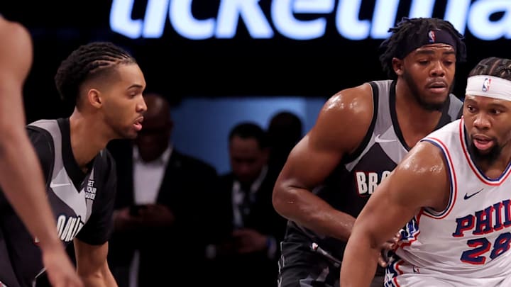 Feb 12, 2025; Brooklyn, New York, USA; Philadelphia 76ers forward Guerschon Yabusele (28) controls the ball against Brooklyn Nets center Day'Ron Sharpe (20) and forward Ziaire Williams (8) during the second quarter at Barclays Center. Mandatory Credit: Brad Penner-Imagn Images