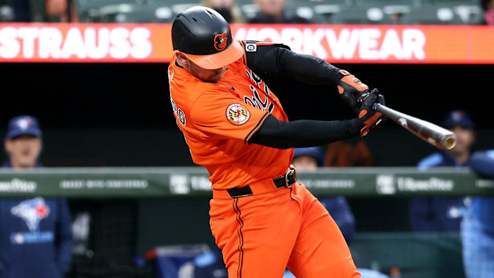 Apr 12, 2025; Baltimore, Maryland, USA; Baltimore Orioles third baseman Jordan Westburg (11) hits a single during the sixth inning against the Toronto Blue Jays at Oriole Park at Camden Yards. 