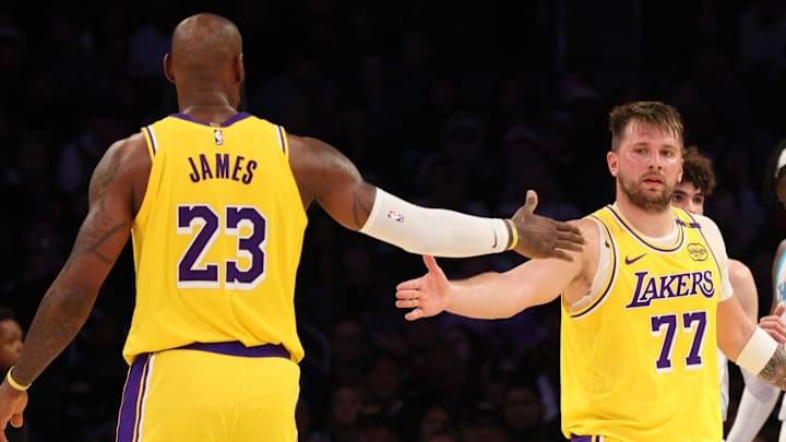 Feb 19, 2025; Los Angeles, California, USA; Los Angeles Lakers forward LeBron James (23) and guard Luka Doncic (77) celebrate after a play during the third quarter against the Charlotte Hornets at Crypto.com Arena. Mandatory Credit: Jason Parkhurst-Imagn Images
