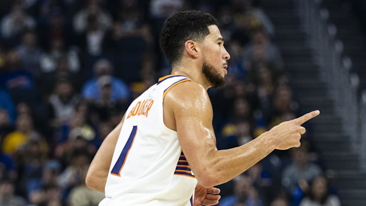 Dec 20, 2025; San Francisco, California, USA; Phoenix Suns guard Devin Booker (1) reacts after he hit a three-point shot against the Golden State Warriors during the first quarter at Chase Center. Mandatory Credit: John Hefti-Imagn Images