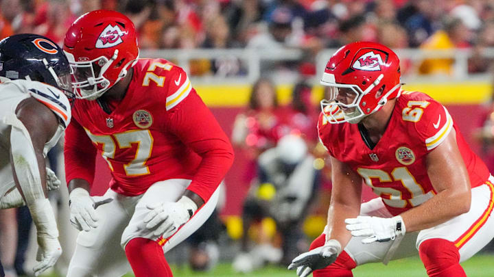 Aug 22, 2025; Kansas City, Missouri, USA; Kansas City Chiefs guard Jaylon Moore (77) and guard C.J. Hanson (61) at the line of scrimmage against the Chicago Bears during the game at GEHA Field at Arrowhead Stadium. Mandatory Credit: Denny Medley-Imagn Images