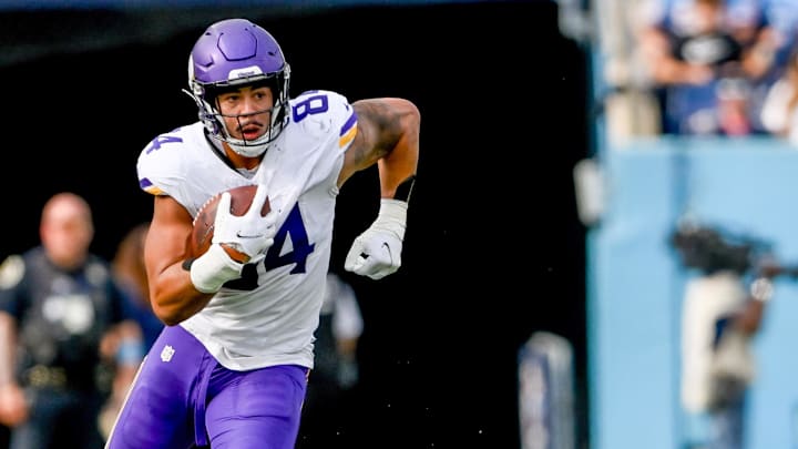 Nov 17, 2024; Nashville, Tennessee, USA; Minnesota Vikings tight end Josh Oliver (84) runs the ball after a made catch against the Tennessee Titans during the first half at Nissan Stadium.