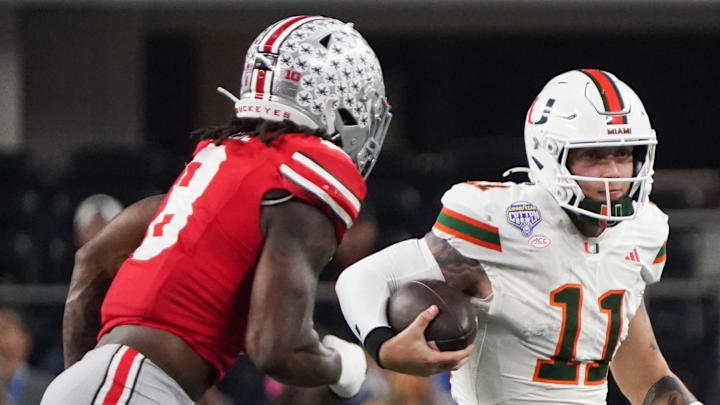 Miami Hurricanes quarterback Carson Beck (11) moves the ball while defended by Ohio State Buckeyes linebacker Arvell Reese (8) in the fourth quarter during the 2025 Cotton Bowl and quarterfinal game of the College Football Playoff at AT&T Stadium. Mandatory Credit: Raymond Carlin III-Imagn Images