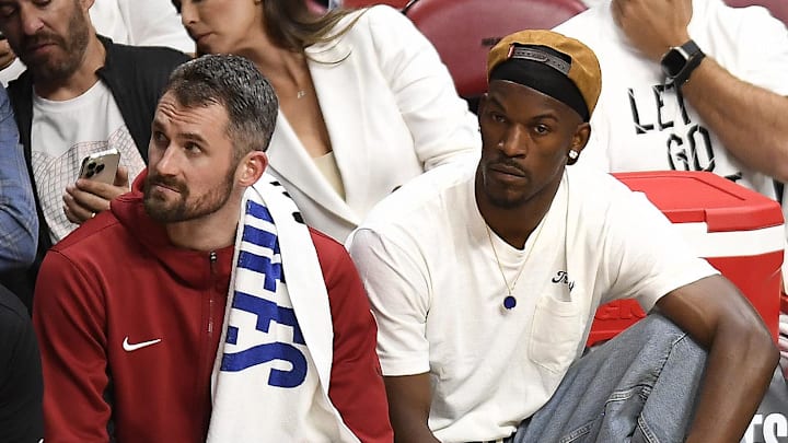 Apr 29, 2024; Miami, Florida, USA; Miami Heat forward Kevin Love (42) and Jimmy Butler (22) watch the Heat fall to the Boston Celtics during the fourth quarter of game four of the first round for the 2024 NBA playoffs at Kaseya Center. Mandatory Credit: Michael Laughlin-Imagn Images