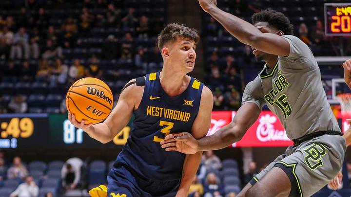 Feb 17, 2024; Morgantown, West Virginia, USA; West Virginia Mountaineers guard Kerr Kriisa (3) drives against Baylor Bears forward Josh Ojianwuna (15) during the second half at WVU Coliseum. Mandatory Credit: Ben Queen-USA TODAY Sports Feb 17, 2024; Morgantown, West Virginia, USA; West Virginia Mountaineers guard Kerr Kriisa (3) drives against Baylor Bears forward Josh Ojianwuna (15) during the second half at WVU Coliseum. Mandatory Credit: Ben Queen-USA TODAY Sports
