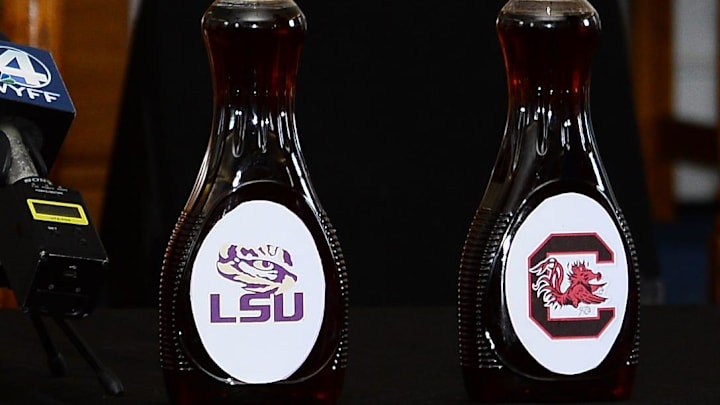LSU Tigers and South Carolina football logos on maple syrup bottles from a commitment ceremony back in 2023.