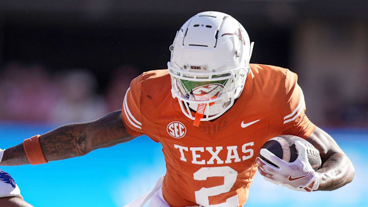 Texas Longhorns wide receiver Matthew Golden (2) stiff arms Kentucky Wildcats defensive back Maxwell Hairston (1) in the first quarter of an NCAA college football game at Darrell K Royal Texas Memorial Stadium in Austin, Texas on Saturday, Nov. 24, 2024.