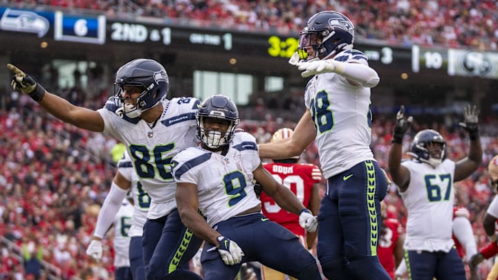 November 17, 2024; Santa Clara, California, USA; Seattle Seahawks running back Kenneth Walker III (9) is congratulated by tight end Pharaoh Brown (86) and tight end AJ Barner (88) for scoring a touchdown against the San Francisco 49ers during the third quarter at Levi's Stadium. November 17, 2024; Santa Clara, California, USA; Seattle Seahawks running back Kenneth Walker III (9) is congratulated by tight end Pharaoh Brown (86) and tight end AJ Barner (88) for scoring a touchdown against the San Francisco 49ers during the third quarter at Levi's Stadium.
