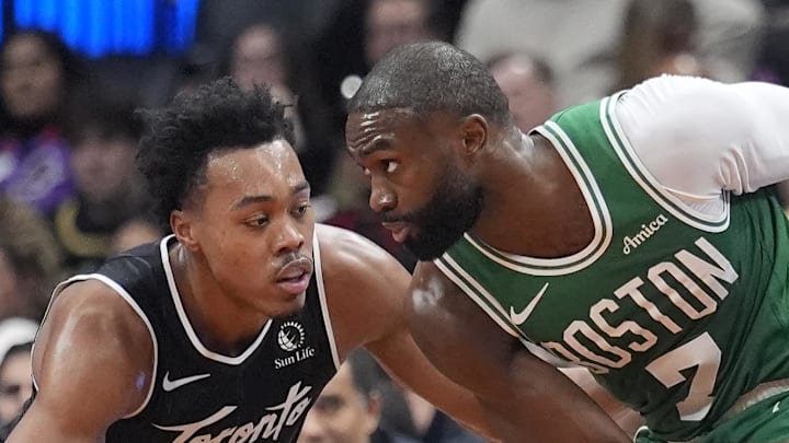 Boston Celtics forward Jaylen Brown controls the ball against Toronto Raptors guard Scottie Barnes. Boston Celtics forward Jaylen Brown controls the ball against Toronto Raptors guard Scottie Barnes.