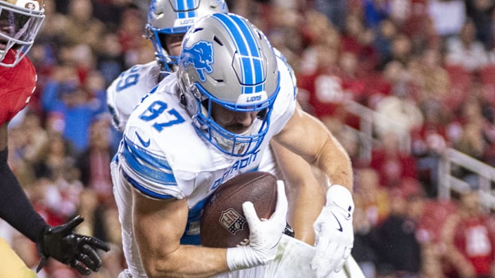 Detroit Lions tight end Sam LaPorta (87) scores a touchdown against San Francisco 49ers cornerback Isaac Yiadom (22) Detroit Lions tight end Sam LaPorta (87) scores a touchdown against San Francisco 49ers cornerback Isaac Yiadom (22)