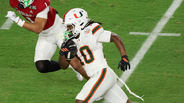 Jan 19, 2026; Miami Gardens, FL, USA; Miami Hurricanes wide receiver Malachi Toney (10) carries the ball defended by Indiana Hoosiers defensive back Amare Ferrell (1) in the fourth quarter during the College Football Playoff National Championship game at Hard Rock Stadium. Mandatory Credit: Kim Klement Neitzel-Imagn Images