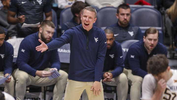 Dec 3, 2025; Morgantown, West Virginia, USA; West Virginia Mountaineers head coach Ross Hodge talks to his players during the first half against the Coppin State Eagles at Hope Coliseum. Mandatory Credit: 